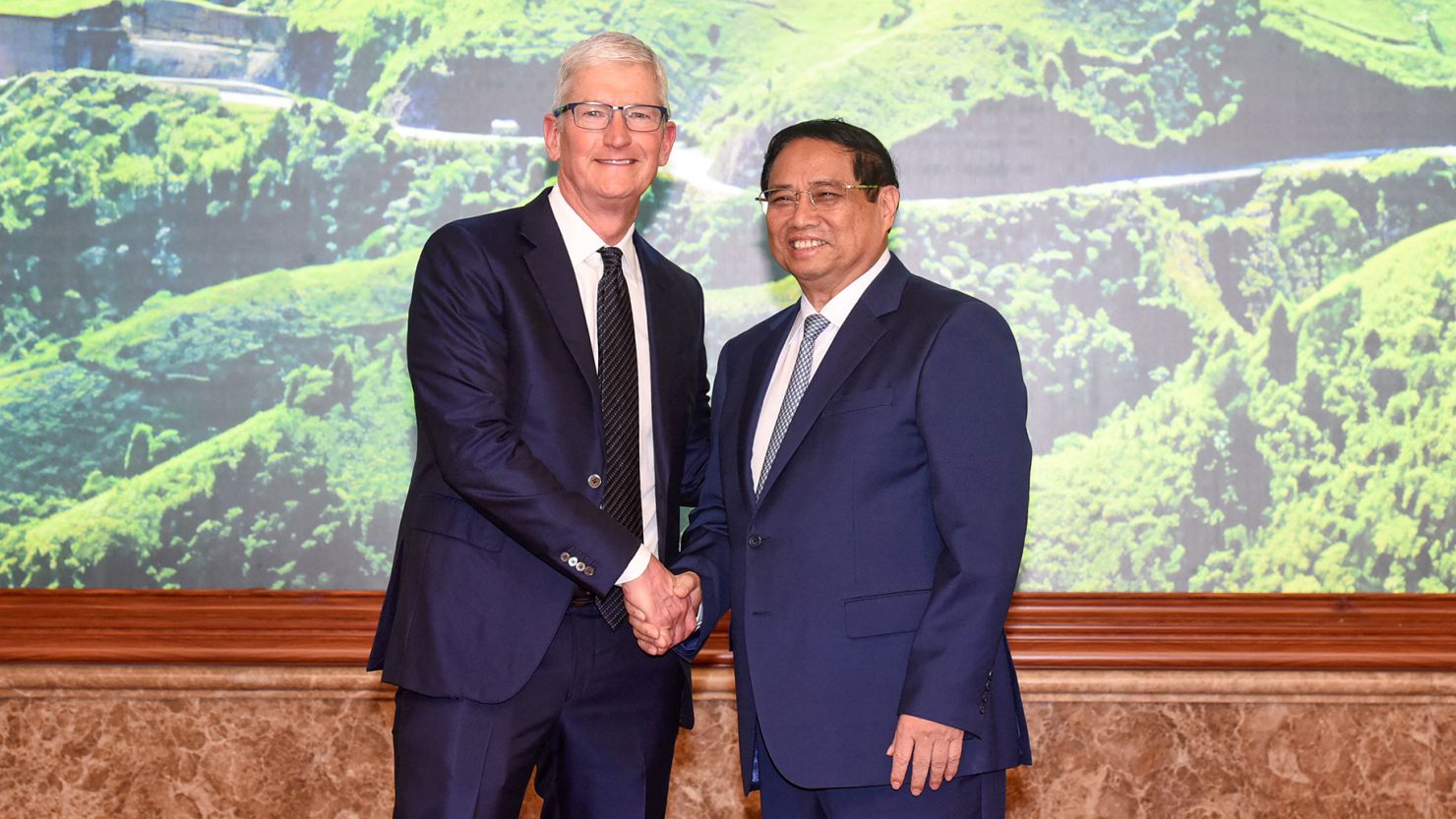 Vietnam's Prime Minister Pham Minh Chinh (left) and Apple CEO Tim Cook during a meeting in Hanoi on April 16, 2024.