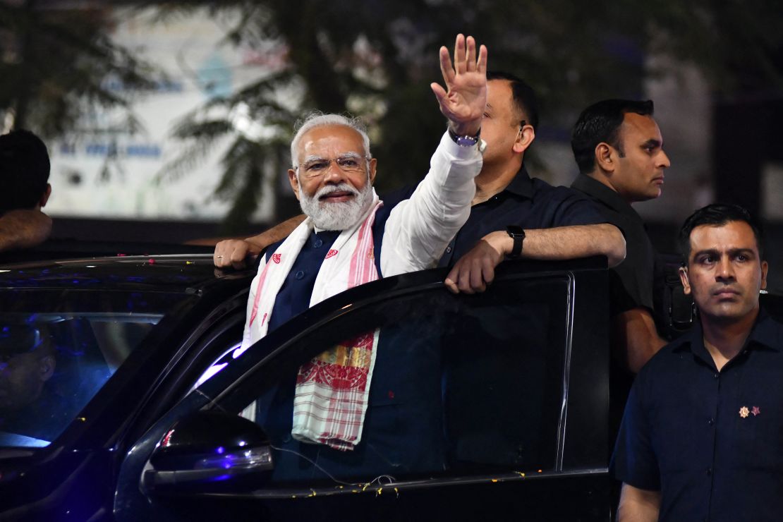 Indian prime minister and leader of the ruling Bharatiya Janata Party Narendra Modi waves to supporters at an election campaign event in Guwahati on April 16, 2024.