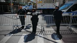 New York police officers patrol outside Manhattan Criminal Court during the second day of the trial of former US President Donald Trump for allegedly covering up hush money payments linked to extramarital affairs in New York City on April 16, 2024.