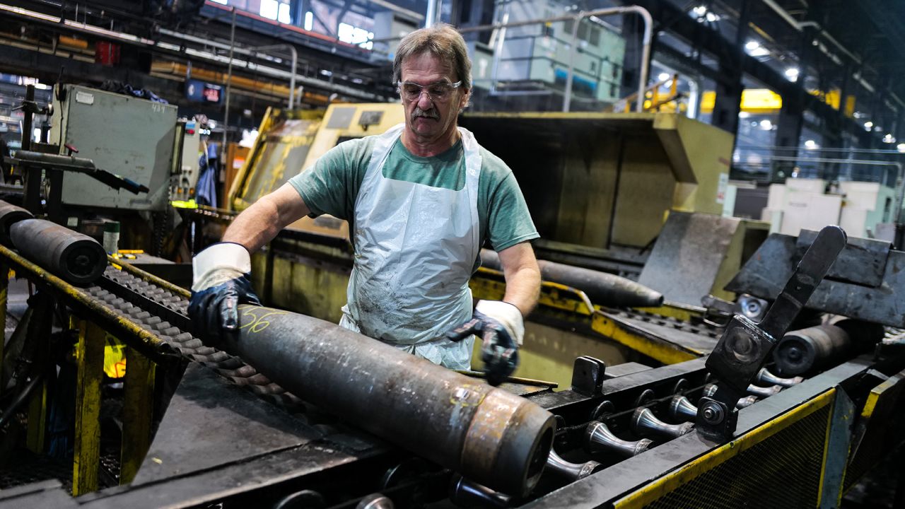TOPSHOT - An employee handles 155 mm caliber shells after the manufacturing process at the Scranton Army Ammunition Plant (SCAAP) in Scranton, Pennsylvania on April 16, 2024. In brick buildings that are more than a century old, nearly in the heart of Joe Biden's Rust Belt hometown of Scranton, Pennsylvania, dated machinery churns artillery for modern conflicts, especially the war in Ukraine. The Scranton Army Ammunition Plant (SCAAP) is making steel tubes for 155 mm caliber shells, which are crucial to Kyiv's efforts to face down Moscow's invasion. (Photo by Charly TRIBALLEAU / AFP) (Photo by CHARLY TRIBALLEAU/AFP via Getty Images)