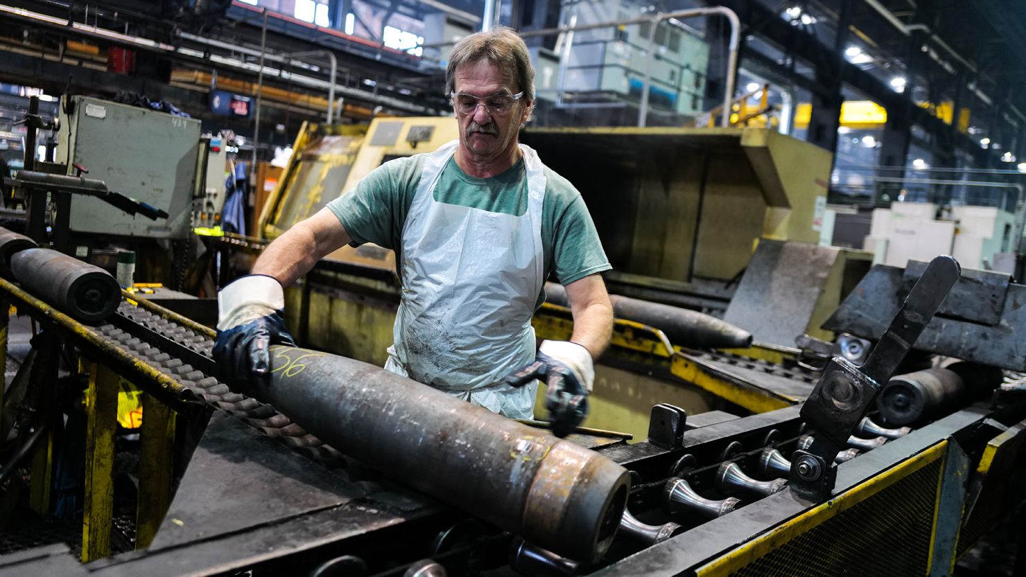 An employee handles 155 mm caliber shells after the manufacturing process at the Scranton Army Ammunition Plant in Scranton, Pennsylvania, on April 16, 2024.