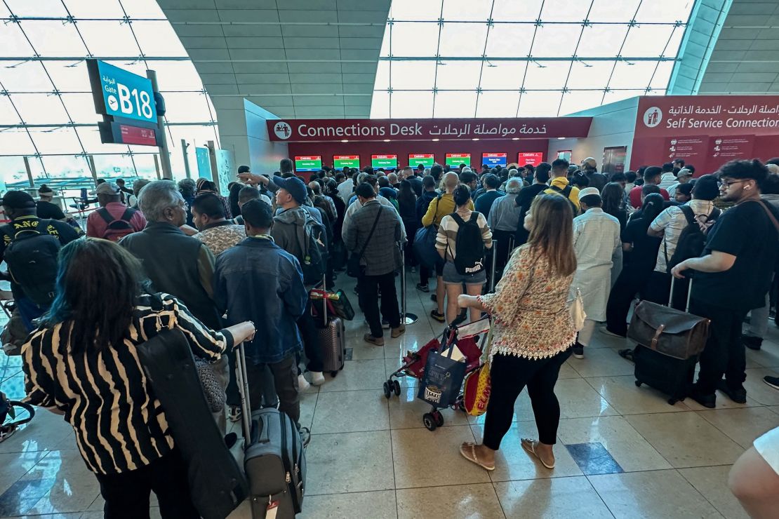 Passengers queue at a flight connection desk at the Dubai International Airport in Dubai on Wednesday.