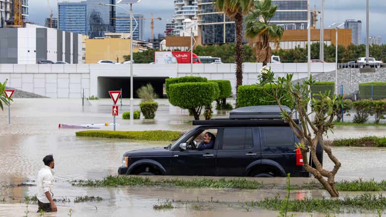 A motorist waits while attempting to navigate flood waters in the Dubai Sports City district of Dubai, United Arab Emirates, on Tuesday, April 16, 2024. The United Arab Emirates experienced its heaviest downpour since records began in 1949, Dubai's media office said in a statement. Photographer: Christopher Pike/Bloomberg via Getty Images