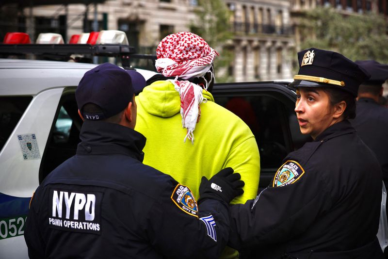 NYPD officers detain a person as pro-Palestinian protesters gather outside of Columbia University in New York City on April 18, 2024. Officers cleared out a pro-Palestinian campus demonstration on April 18, a day after university officials testified about anti-Semitism before Congress. Leaders of Columbia University defended the prestigious New York school's efforts to combat anti-Semitism on campus at a fiery congressional hearing on April 17. (Photo by Kena Betancur / AFP) (Photo by KENA BETANCUR/AFP via Getty Images)