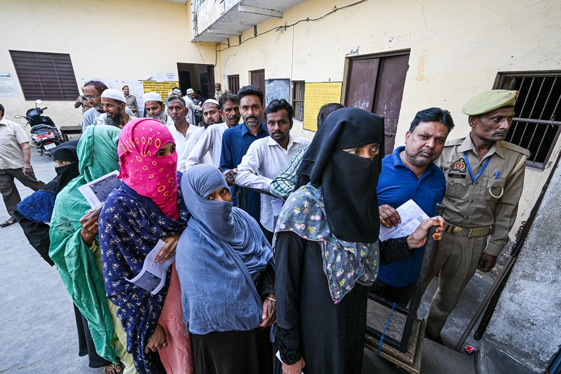 Voters queue at a polling station during the first phase of voting for national elections in Muzaffarnagar district, Uttar Pradesh, India, on Friday, April 19, 2024.