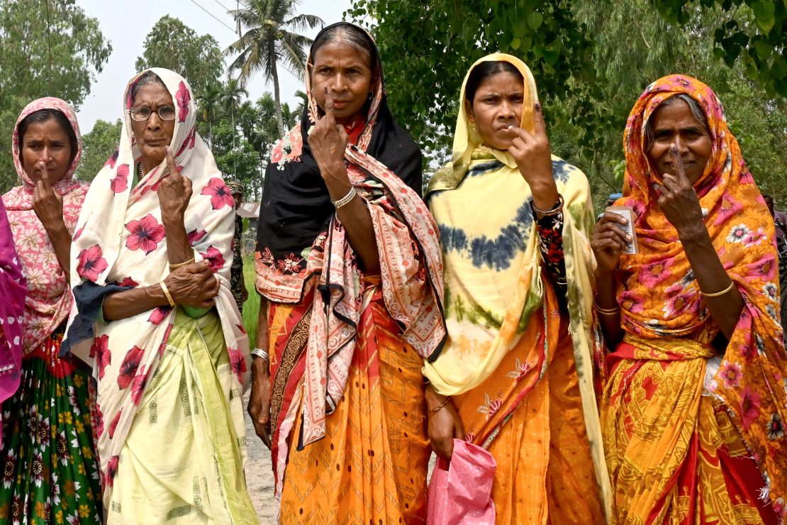 Women shows their inked fingers after casting their ballots to vote near the India-Bangladesh border in Seoraguri village, Dinhata district of Cooch Behar in the country's West Bengal state on April 19, 2024.