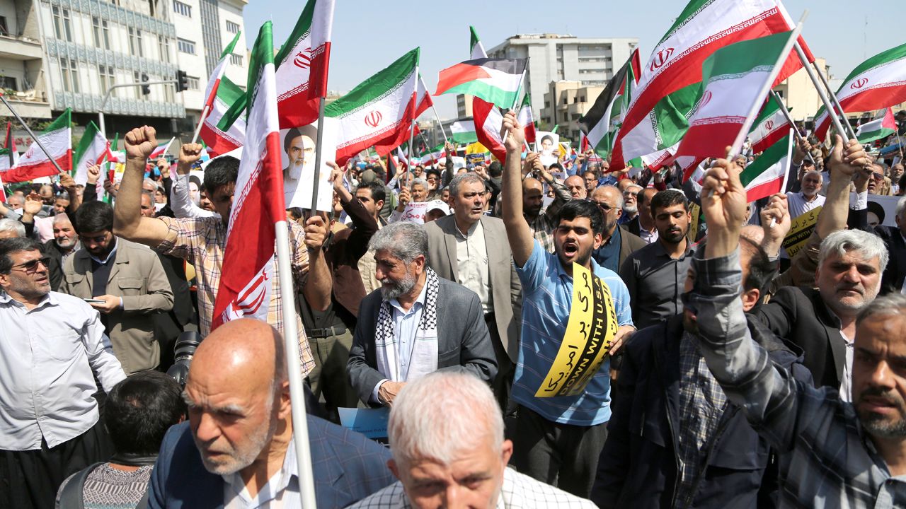 TEHRAN, IRAN - APRIL 19: People march with flags and banners to celebrate Iran's April 13 attack on Israel and protest Israel, which is accused of carrying out the attack that caused explosions in Isfahan and Tabriz on April 19, 2024 in Tehran, Iran. (Photo by Fatemeh Bahrami/Anadolu via Getty Images)