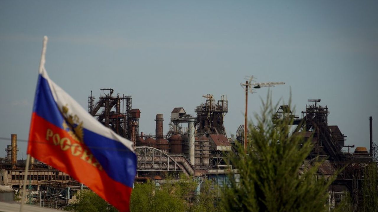 This photograph taken on April 20, 2024, shows a general view of Azovstal steel plant through the Russian national flag in Mariupol, in Russian-controlled Ukraine, amid the Russia-Ukraine conflict. (Photo by STRINGER / AFP) (Photo by STRINGER/AFP via Getty Images)