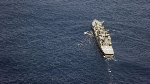 Photo taken from a Kyodo News plane on April 21, 2024, shows a Japan Maritime Self-Defense Force ship searching for two MSDF helicopters in waters east of Torishima Island in the Izu Island chain in the Pacific after they crashed during a drill the night before, leaving at least one of the eight crew members dead, with the other seven missing. (Photo by Kyodo News via Getty Images)