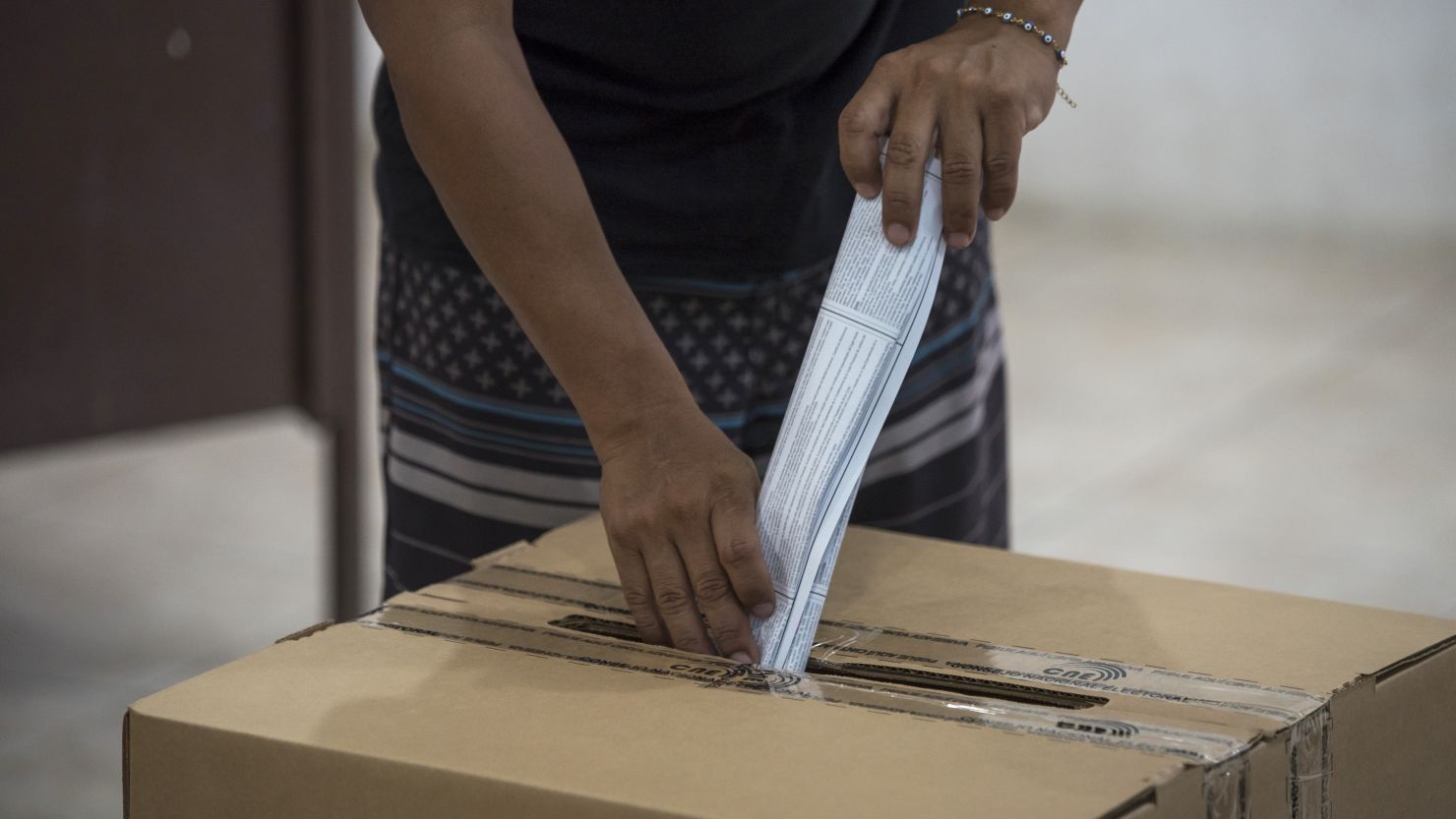 A voter casts a ballot at a polling station during Ecuador's national referendum in Olon, Santa Elena province, on April 21, 2024.