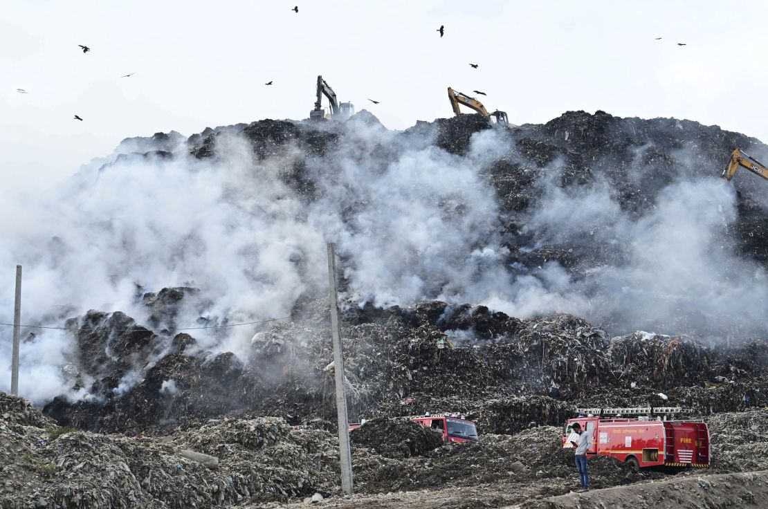 Firemen work to douse the fire at Ghazipur landfill on April 22, 2024 in New Delhi, India.