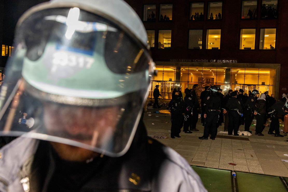 NYPD officers block off an encampment set up by pro-Palestinian students and protesters on the campus of New York University (NYU) to protest the Israel-Hamas war as other officers detain the remaining protesters and clear the camp, in New York on April 22.