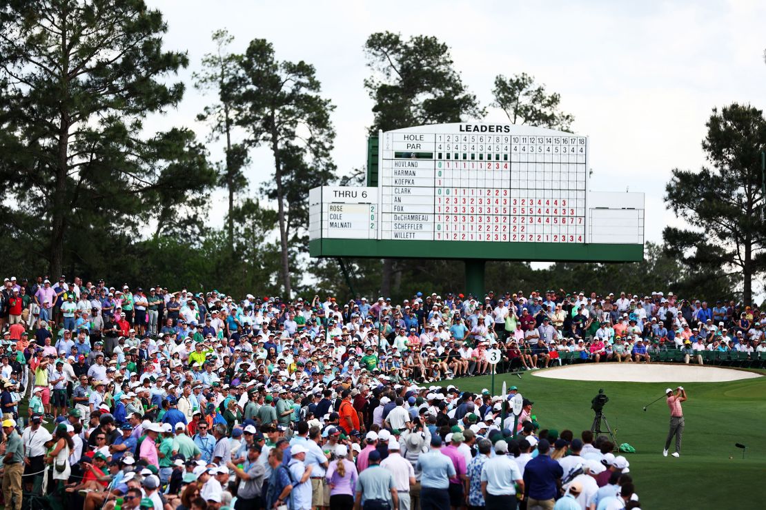 Fans flock to watch Woods tee off from the third tee on Thursday.