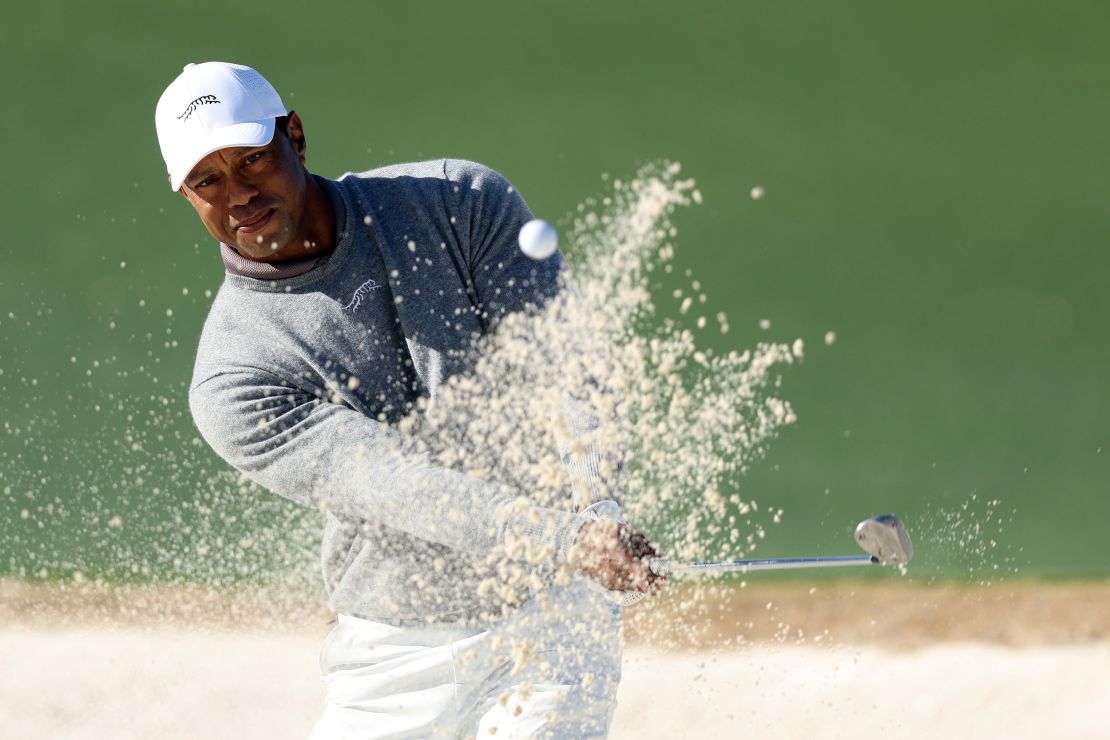 Woods escapes a bunker during the first round.