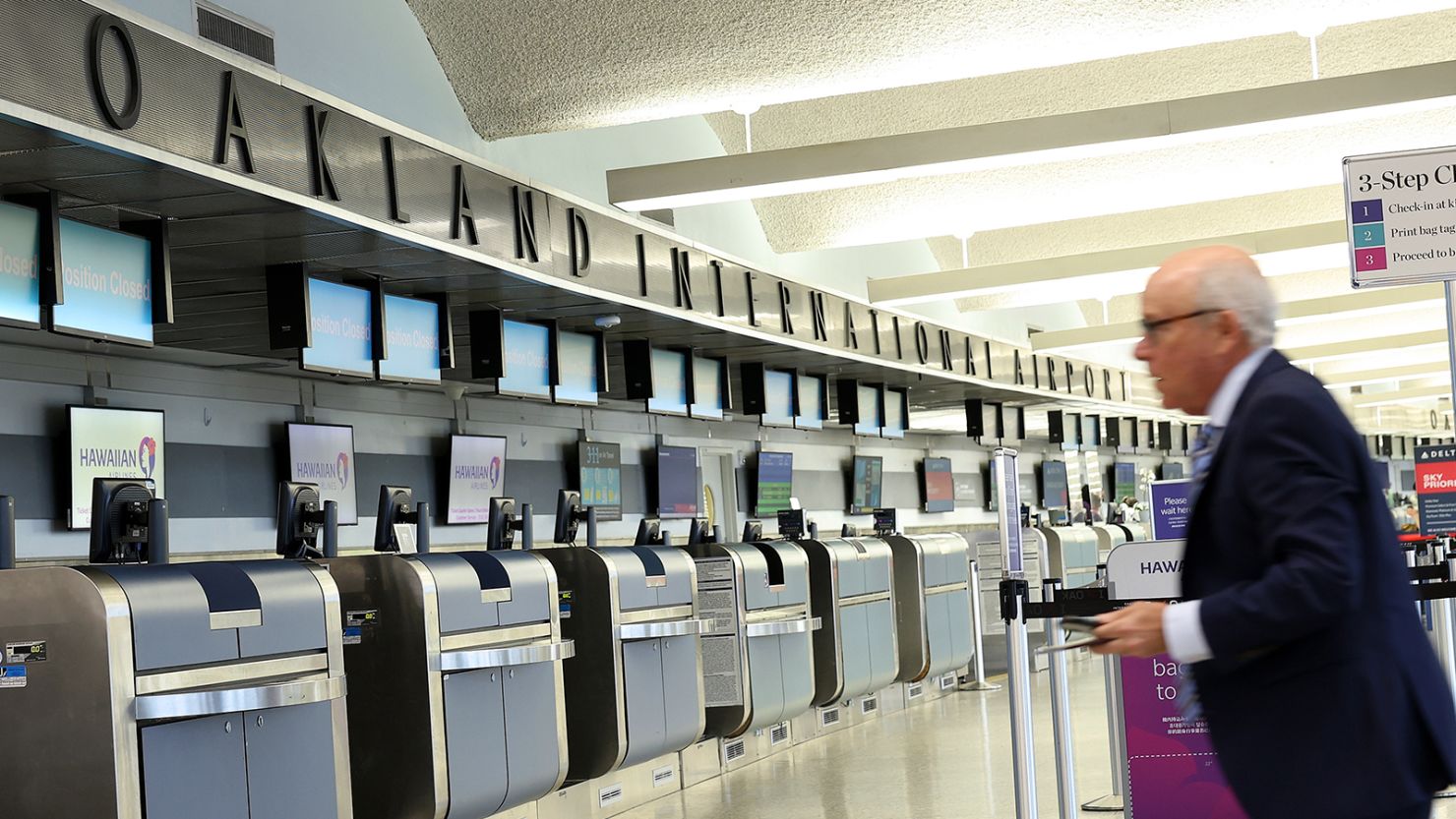 A traveler walks through San Francisco Bay Oakland International, whose IATA code is still OAK.