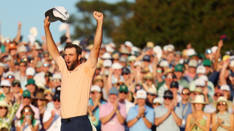 AUGUSTA, GEORGIA - APRIL 14: Scottie Scheffler celebrates on the 18th green after sealing his second major victory at the 2024 Masters in Augusta, Georgia.