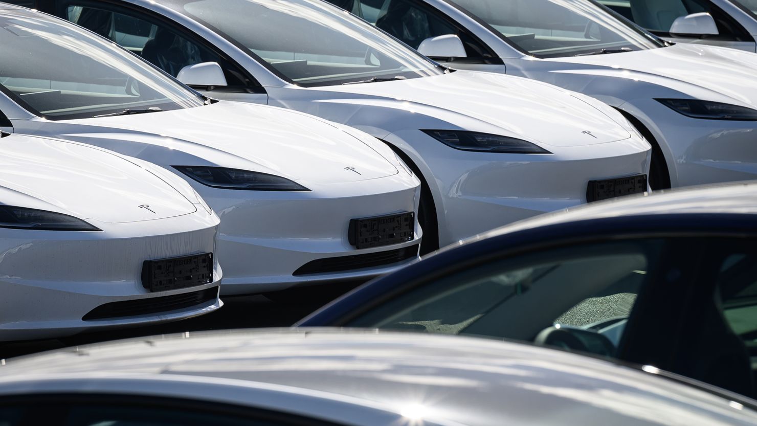Rows of new Tesla cars are seen in a holding area near a customer collection point in London, England.
