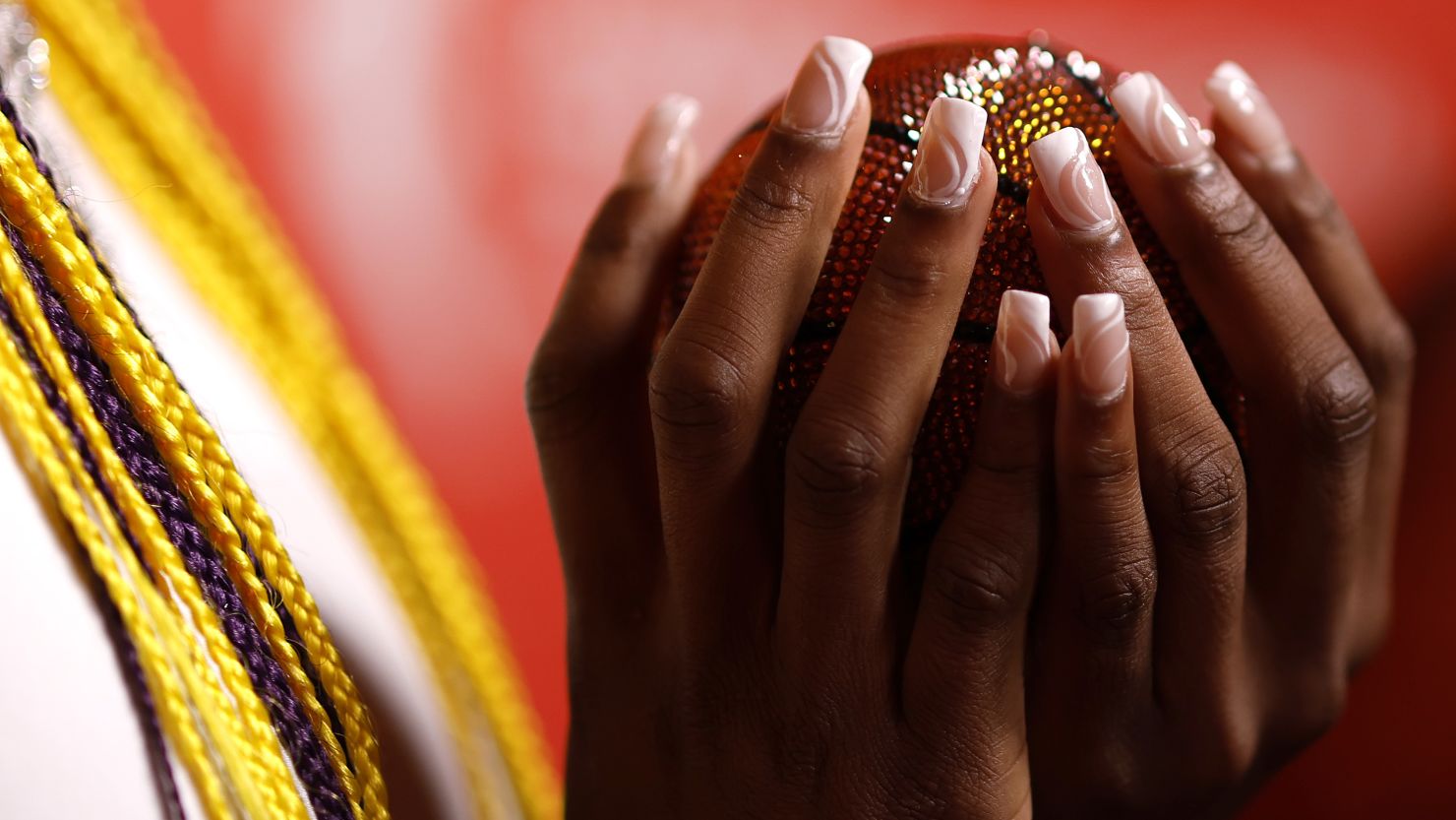 A detailed view of a bejeweled basketball in the hands of Aaliyah Edwards prior to the 2024 WNBA Draft.