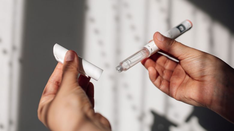 Semaglutide injection pen or cartridge pen for diabetics and weight loss in female hand. Medical equipment for diabetes patients