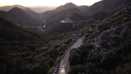 In an aerial view, a vehicle drives past a proposed expansion area (L) of the San Gabriel Mountains National Monument in the Angeles National Forest on April 16, 2024, near La Cañada Flintridge, California.
