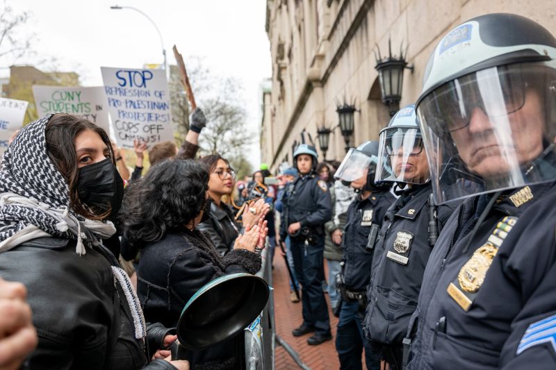 NEW YORK, NEW YORK - APRIL 18: Students and pro-Palestinian activists face police as they gather outside of Columbia University to protest the university's stance on Israel on April 18, 2024 in New York City. The protests come after numerous students were arrested earlier in the day after setting up tents on the university lawn in support of Gaza. (Photo by Spencer Platt/Getty Images)