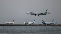 An EVA Air plane lands as United, Frontier and Alaska Airlines planes are taxiing for takeoff at San Francisco International Airport (SFO) in San Francisco, California, United States on April 22, 2024.