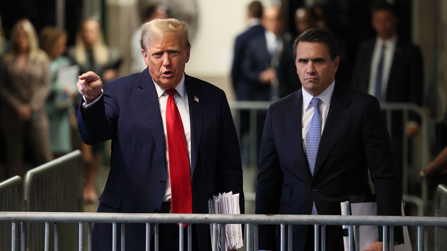 Former President Donald Trump speaks to the media alongside his attorney Todd Blanche (R) outside the courtroom at Manhattan Criminal Court on April 23, 2024.