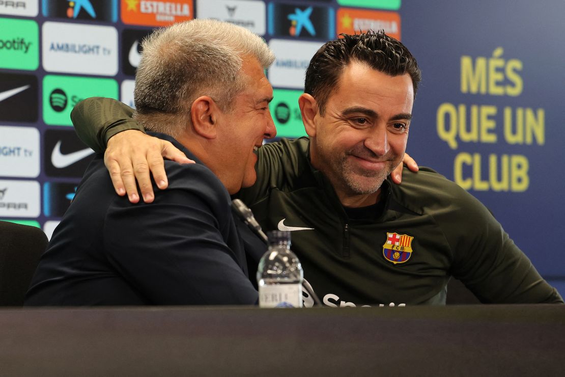 Xavi and Laporta embrace at Thursday's press conference.