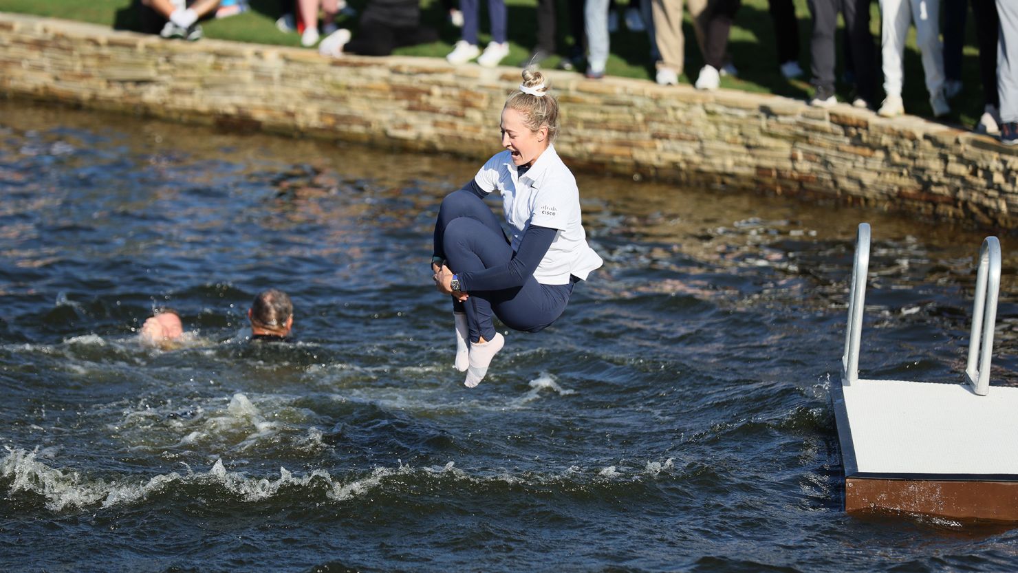 Nelly Korda jumps into the water after winning The Chevron Championship at Carlton Woods in The Woodlands, Texas.