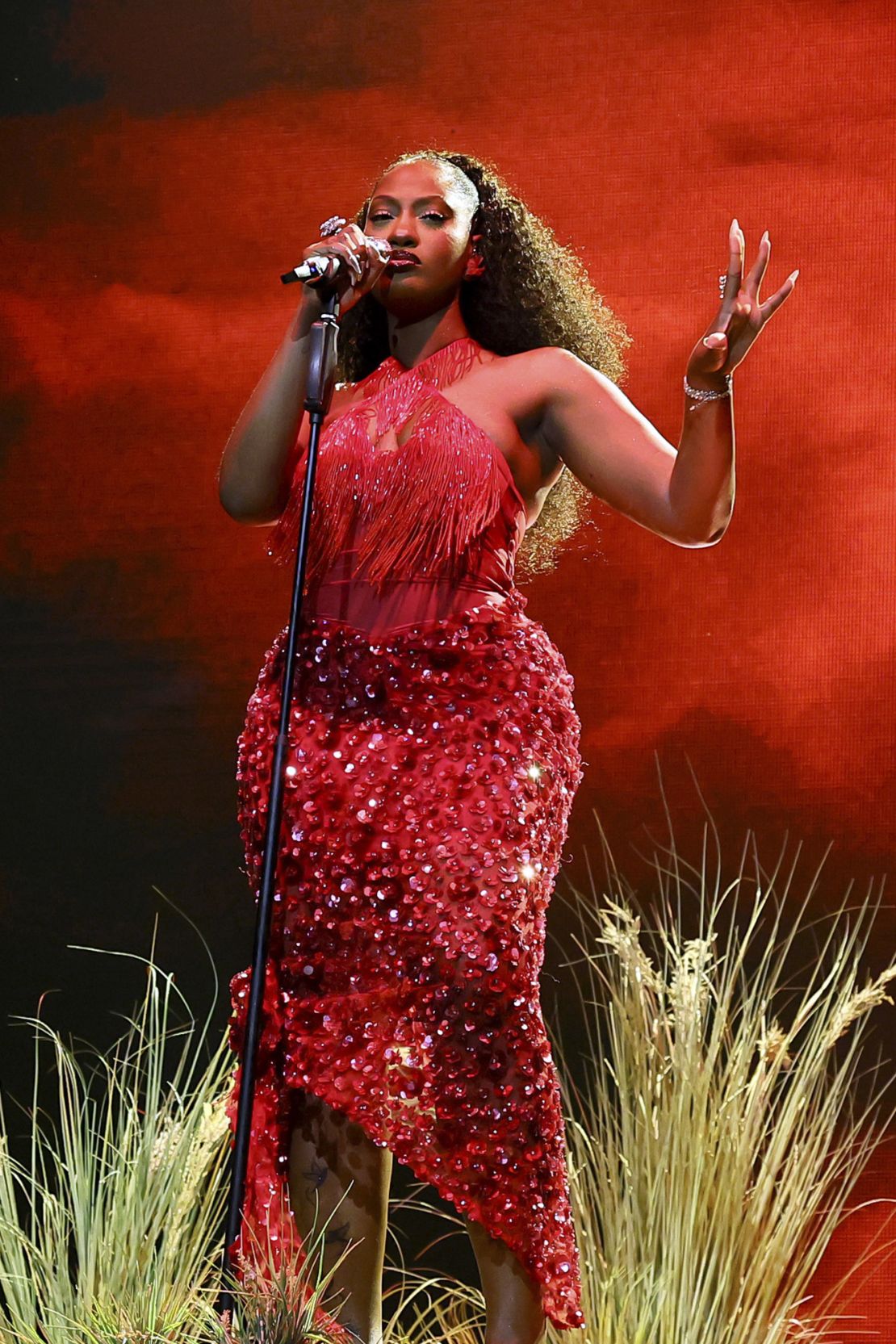 At the Mojave Tent during the second weekend, Tems performed in a embellished ruby-red dress with fringe detailing.