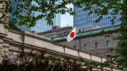 Japan's national flag flutters at the Bank of Japan headquarters in central Tokyo on April 26, 2024.