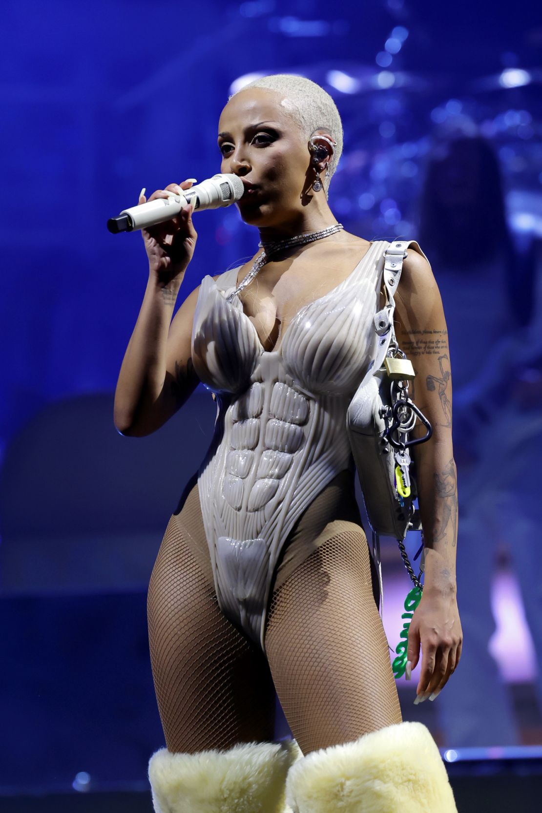 During a costume change in the middle of her set on the second weekend, Doja Cat wore a custom Natasha Zinko muscular body suit and furry over-the-knee boots.