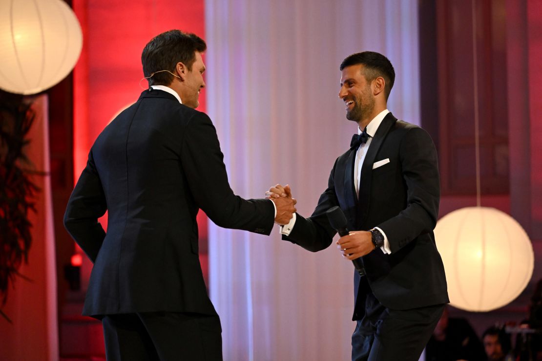Djokovic accepts the award on stage from NFL legend Tom Brady.