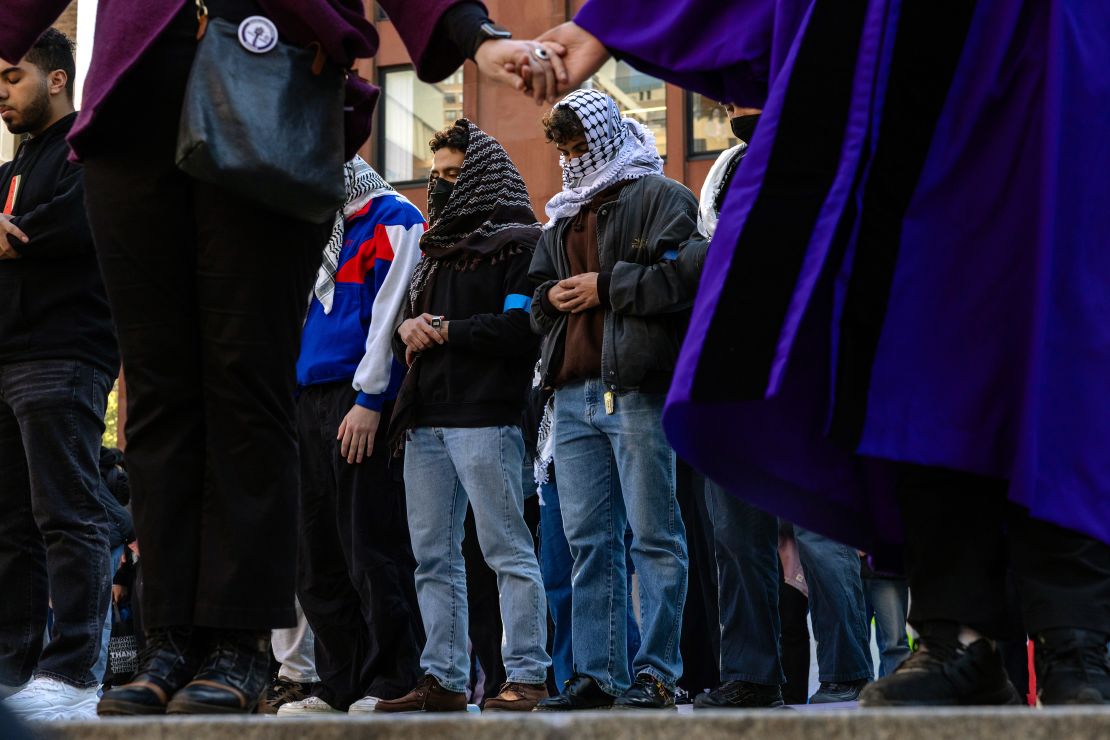 People pray as New York University students set up a "Liberated Zone" tent encampment in Gould Plaza at NYU Stern School of Business in New York City on April 22.