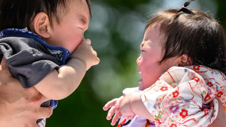 Babies attend an event with sumo wrestlers in Tokyo on April 28, 2024.