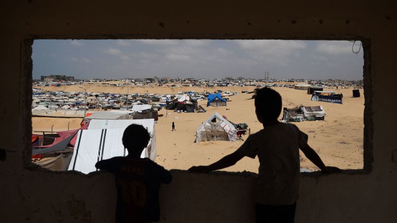 Palestinian children stand in a camp for displaced people in Rafah in the southern Gaza Strip in April.