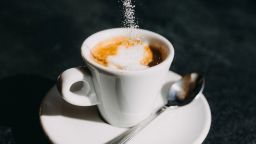 Sugar Pouring to Espresso Cup - stock photo