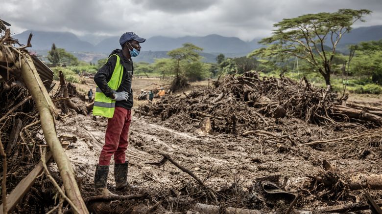 A man looks on while working in an area full of damaged trees, mud and debris carried by water following flash floods and landslides in Mai Mahiu, on April 30, 2024. At least 48 people died on April 29, 2024 when a dam burst its bank near a town in Kenya's Rift Valley, President of Kenya William Ruto said on April 30, 2024. The disaster raises the total death toll over the March-May wet season in Kenya to more than 170 as heavier than usual rainfall pounds East Africa, compounded by the El Nino weather pattern. (Photo by LUIS TATO / AFP) (Photo by LUIS TATO/AFP via Getty Images)