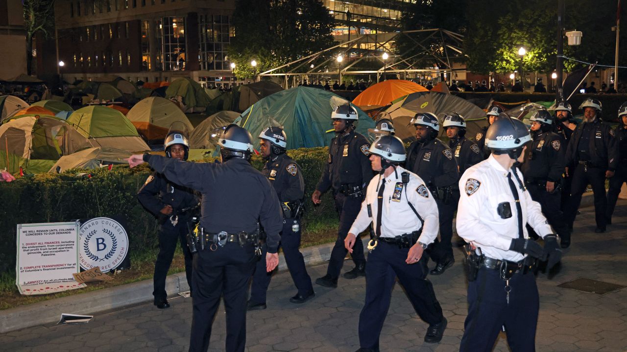 NYPD officers in riot gear enter Columbia University's encampment as they evict a building that had been barricaded by pro-Palestinian student protesters in New York City on April 30, 2024. Dozens of helmeted police flooded Columbia University's campus in the heart of New York City on April 30, 2024 to evict a building occupied by pro-Palestinian student protesters and detain demonstrators. Police climbed into Hamilton Hall via a second floor window they reached from a laddered truck, before leading handcuffed students out of the building into police vans. (Photo by Jia Wu / AFP) (Photo by JIA WU/AFP via Getty Images)