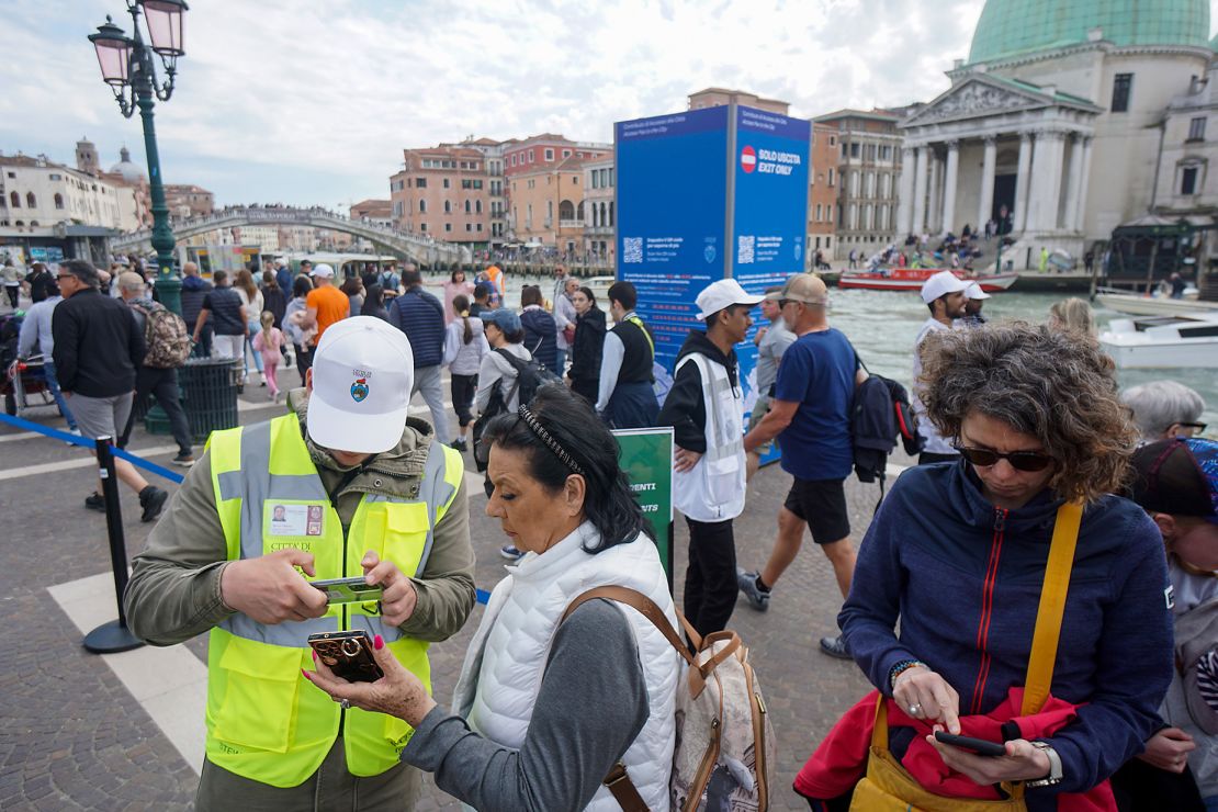 Tickets are checked in Venice, Italy, during its world-first experiment to introduce an entry fee for day-trippers.