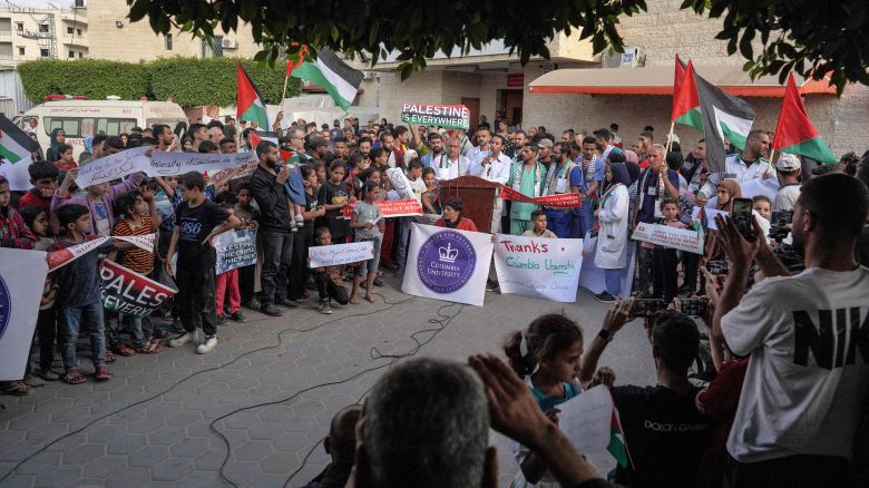 Members of a hospital's medical staff join a rally to thank pro-Palestinian student solidarity initiatives in US and Canadian universities on their campuses, in Deir el-Balah in the central Gaza Strip on May 1, 2024.