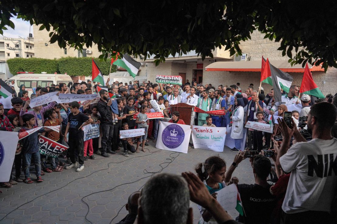 Members of a hospital's medical staff in Deir al-Balah join a rally to thank pro-Palestinian students in the US on May 1, 2024.