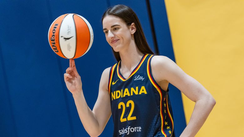 Caitlin Clark poses for photos during media day after being drafted by the Indiana Fever.