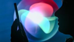 EDMONTON, CANADA - APRIL 28:
An image of a woman holding a cell phone in front of the Siri logo displayed on a computer screen, on April 29, 2024, in Edmonton, Canada. (Photo by Artur Widak/NurPhoto via Getty Images)