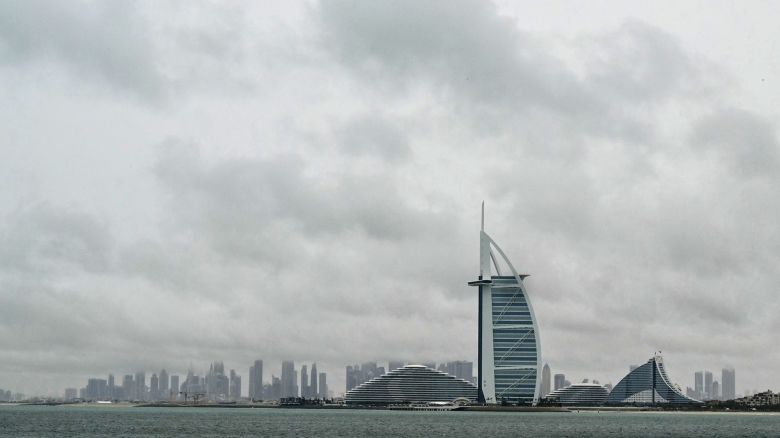 Thick clouds fill the sky above the Burj Al-Arab tower in Dubai on May 2, 2024, as heavy rains returned to the United Arab Emirates just two weeks after record downpours that experts linked to climate change. (Photo by Giuseppe CACACE / AFP) (Photo by GIUSEPPE CACACE/AFP via Getty Images)