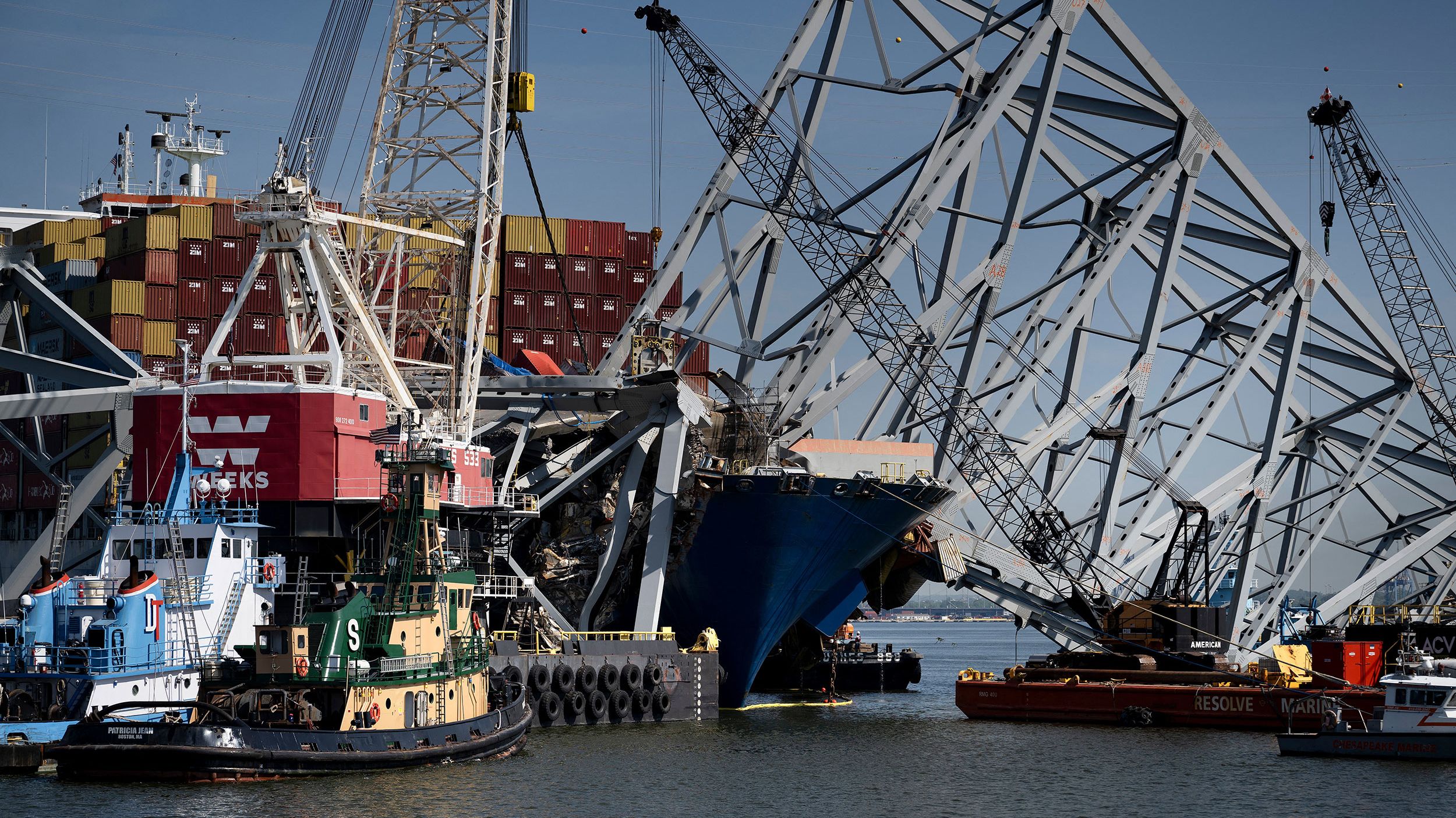 The cargo ship Dali is seen stuck in the remains of the Key Bridge as workers remove debris at the Patapsco River entrance to Baltimore Harbor on May 2, 2024, in Baltimore, Maryland.