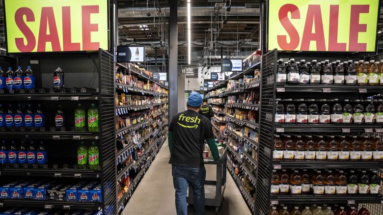 Workers stock shelves at an Amazon Fresh grocery store in Seattle, Washington, US, on Thursday, May 2, 2024.