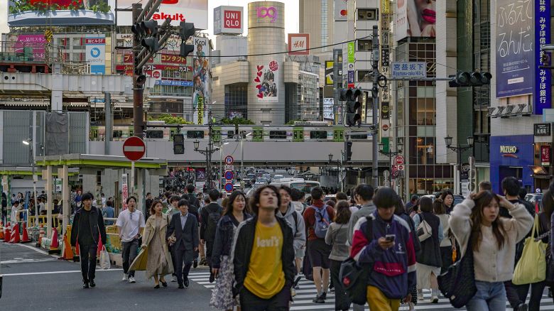 Pedestrians cross an intersection in the Shibuya district of Tokyo, Japan, on Thursday, May 2, 2024.