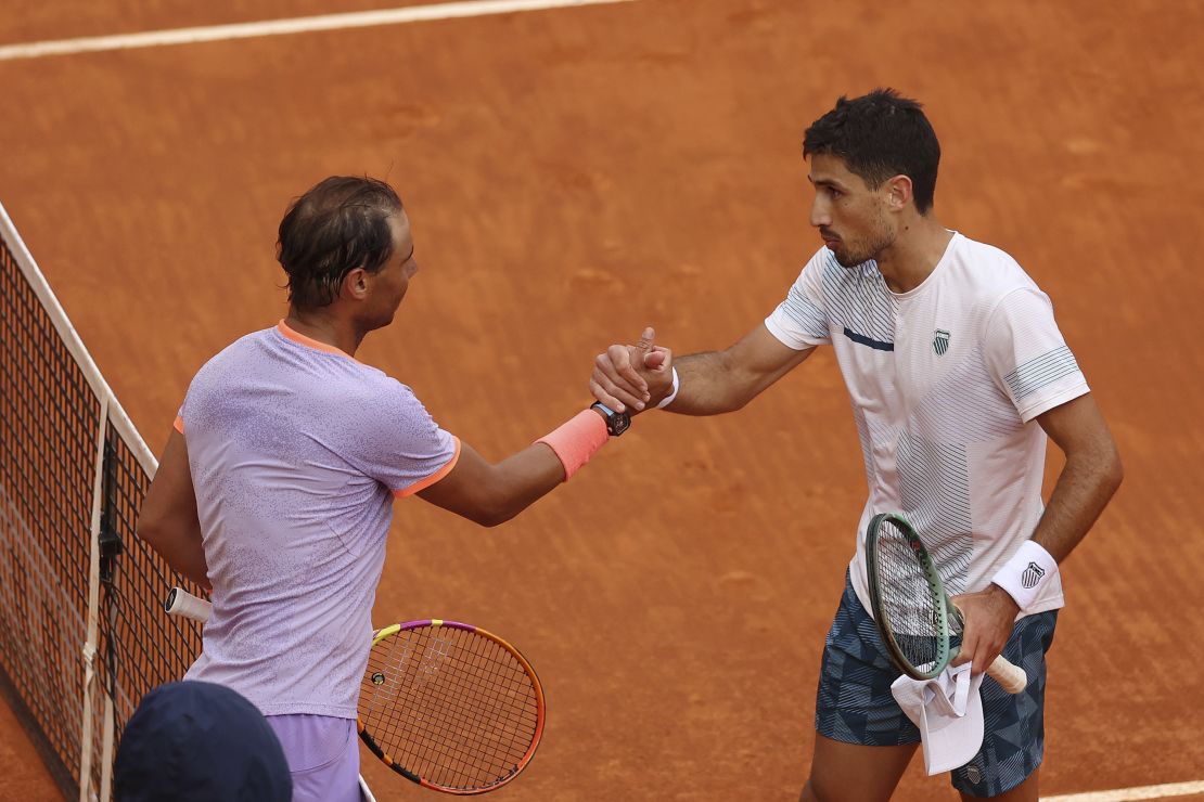 Nadal and Cachín shake hands at the net after their Madrid Open match.
