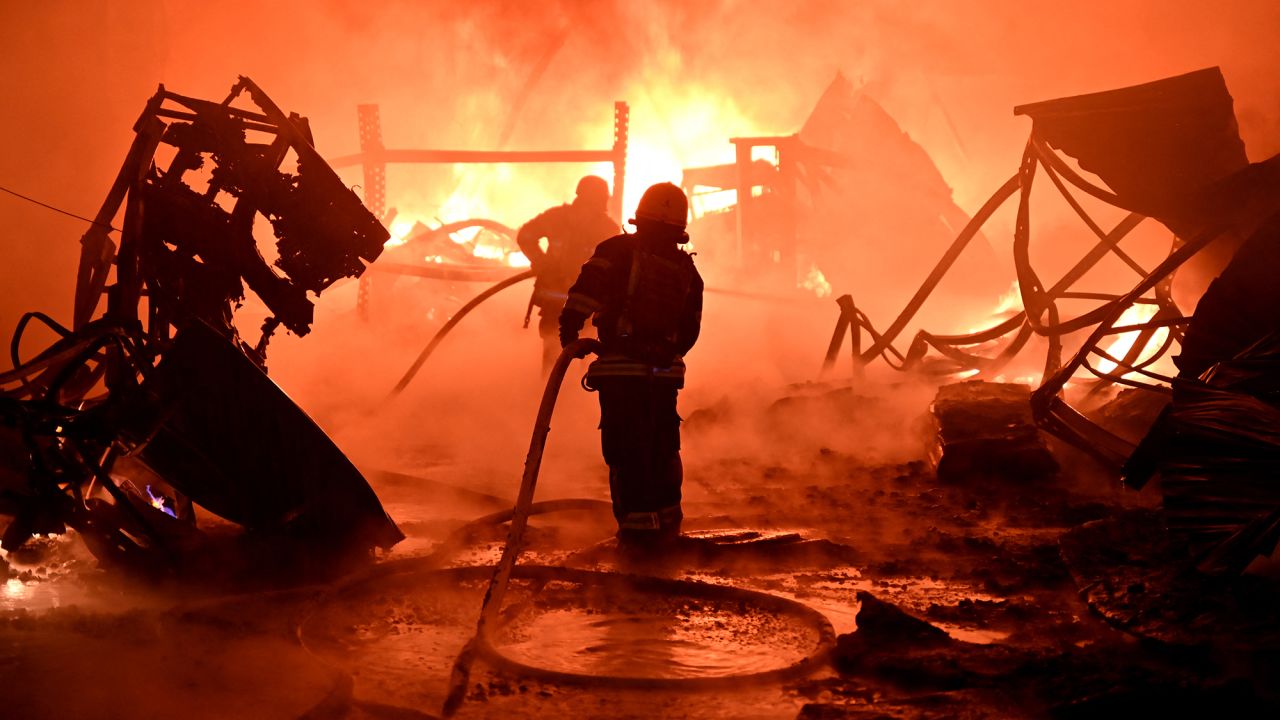 TOPSHOT - Ukrainian firefighters work to extinguish a fire at the site of a drone attack on industrial facilities in Kharkiv on May 4, 2024, amid the Russian invasion of Ukraine. (Photo by SERGEY BOBOK / AFP) (Photo by SERGEY BOBOK/AFP via Getty Images)
